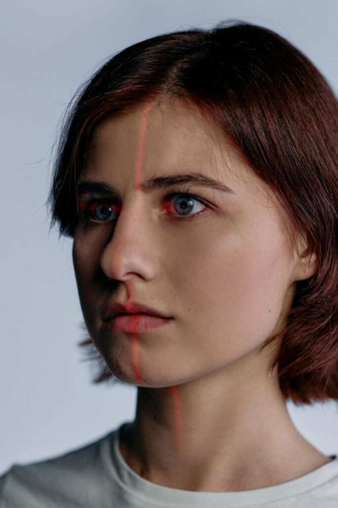 Young woman with short auburn hair and clear skin looking towards the camera