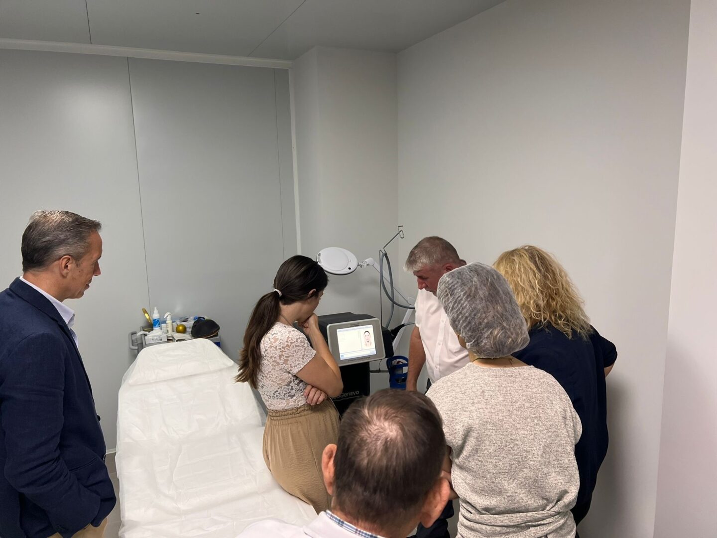 A NeoGen trainer taking a group of practitioners through the NeoGen EVO in a treatment room